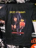 black tee printed band name Joan Jett and the Blackhearts in yellow Joan Jett holding a cherry bomb and a lighter says cherry bomb
